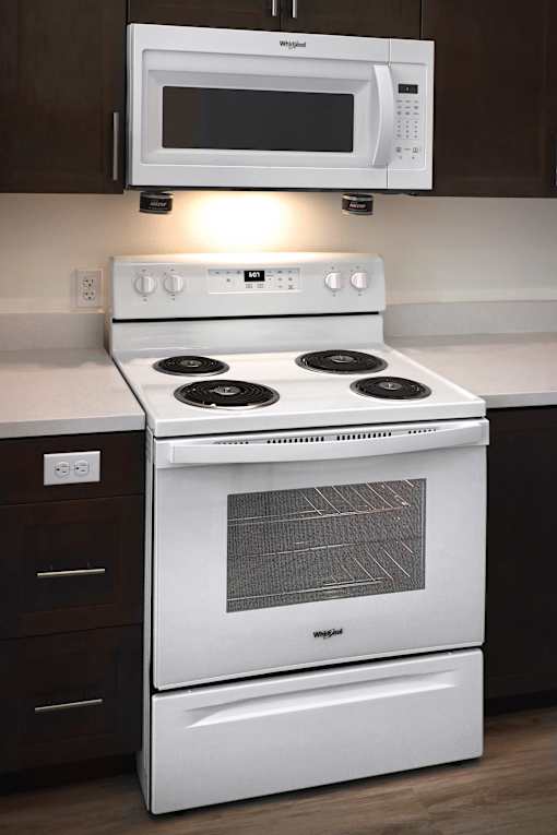 A white stove and microwave in a kitchen.