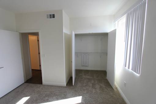 A room with a carpeted floor and white walls.