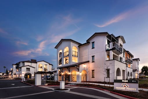 A modern building with a sign that reads "Supreme Pointe" in front of it.
