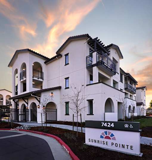 A building with the number 7424 and the name Sunrise Pointe on a sign in front of it.