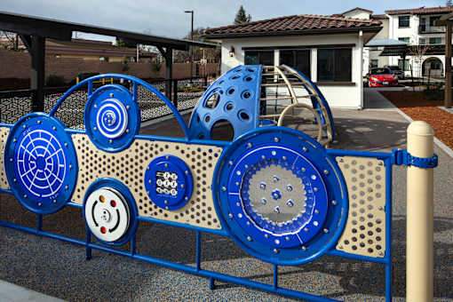 A playground with a blue and white play structure.