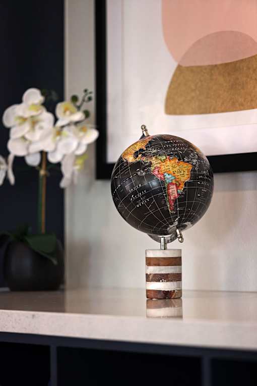 A black globe with a wooden stand is placed on a shelf.