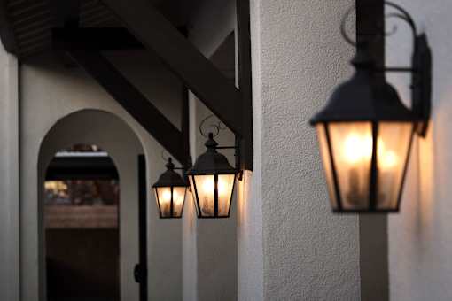 Three hanging lights on a wall.