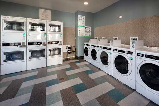 A laundromat with a variety of washing machines.