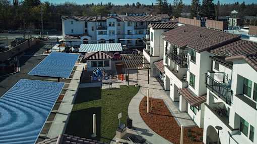 A view of a courtyard with a blue tarp covering a building.