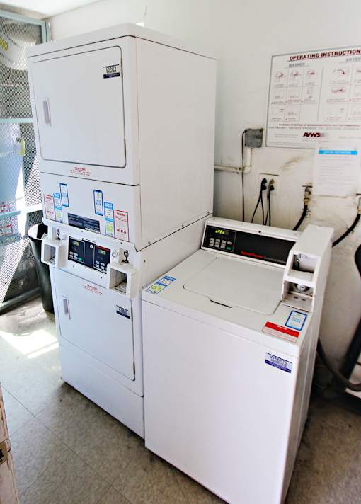 A white appliance with a control panel and a blue sticker on the front.