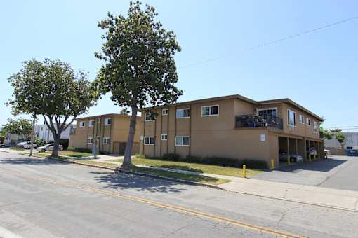 A brown building with a tree in front of it.