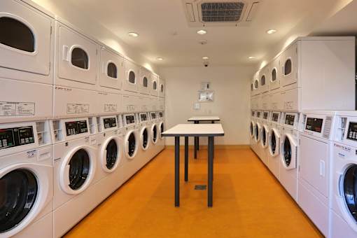 A row of washing machines in a laundromat.