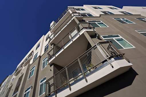 A tall building with balconies and windows.