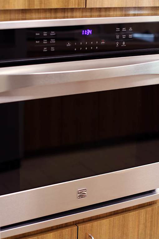 A stainless steel oven with a digital clock showing 11:34.