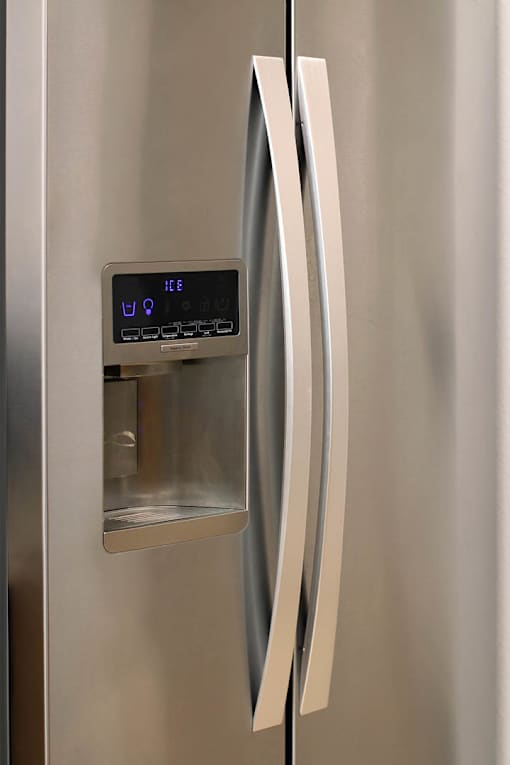 A stainless steel refrigerator with a digital display on the door.