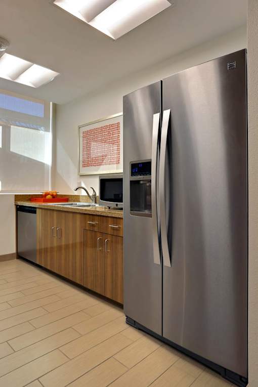A modern kitchen with a stainless steel refrigerator.