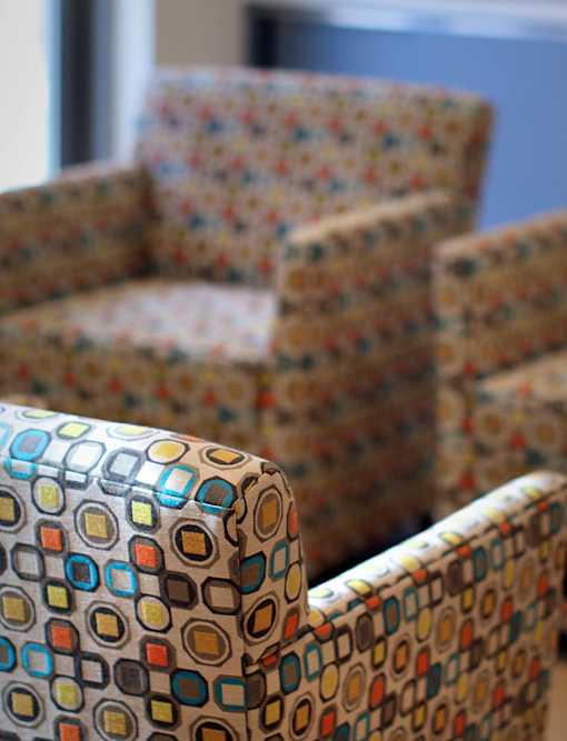 Two chairs with different colored patterns on them.