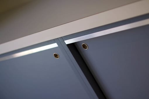 A close up of a blue surface with two holes.