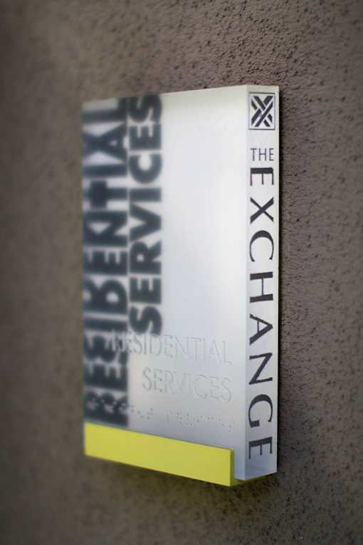 A book titled "The Exchange Residential Services" is placed on a surface.