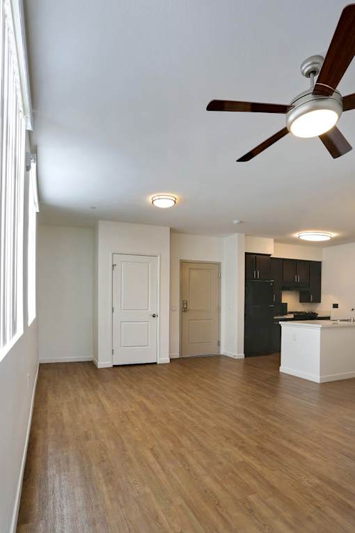 A room with a ceiling fan and lights.