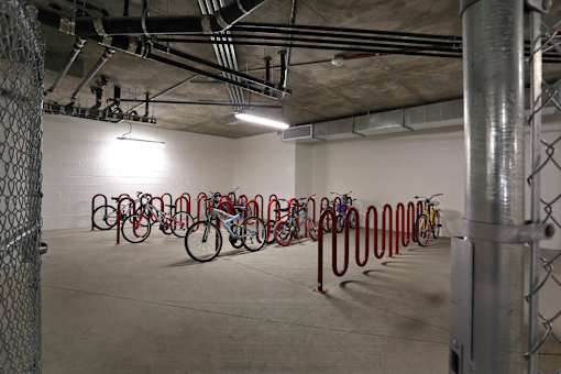 A bike rack with bikes in a parking garage.