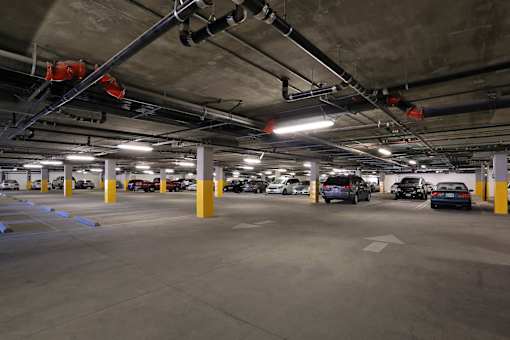 A parking garage with cars parked in it.