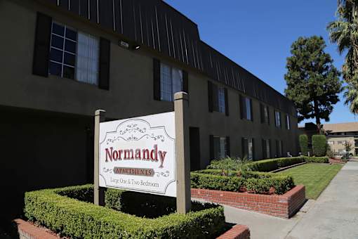 A Normandy sign is in front of a building.