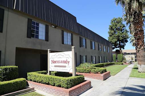 A building with a sign that says Normandy in front of it.