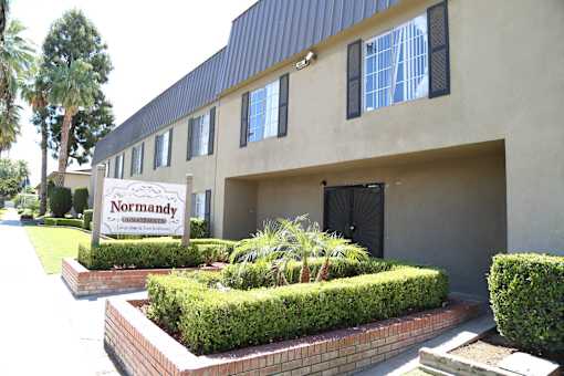 A building with a sign that says Normandy in front of it.