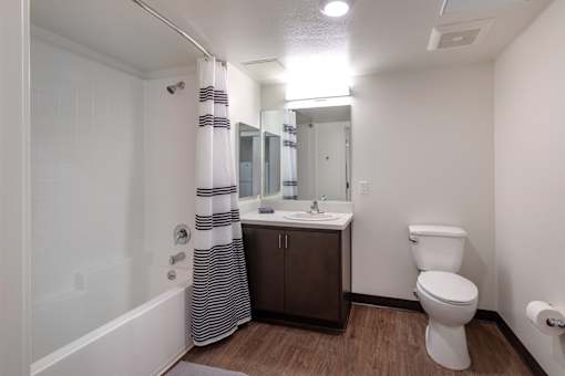 A white toilet sits next to a sink in a bathroom.