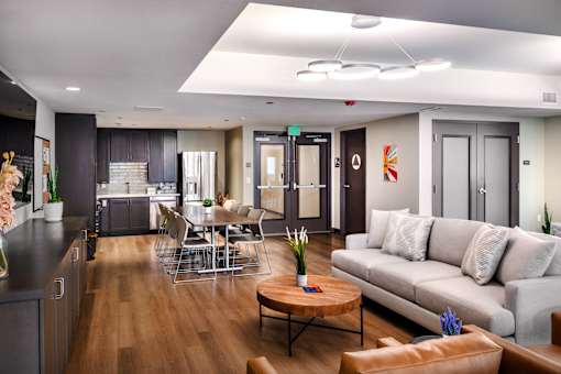 A modern living room with a grey couch and a wooden coffee table.