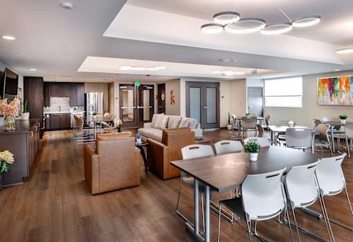 A modern living room with a dining table and chairs.