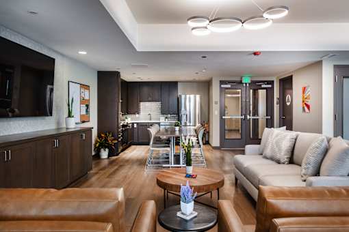 A modern living room with brown leather furniture and a wooden coffee table.