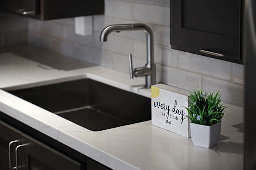 A kitchen sink with a sign that says "every day fresh is a heart".