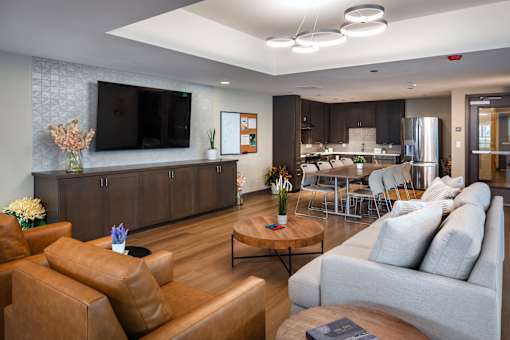 A living room with a brown leather couch and a wooden coffee table.