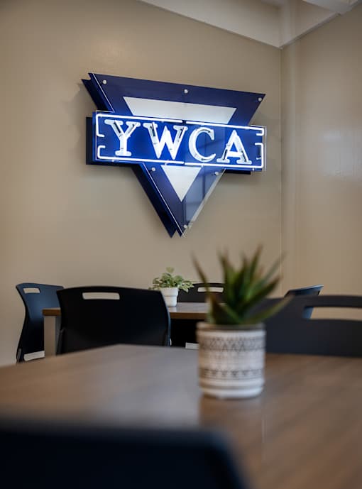 A conference room with a YWCA sign on the wall.