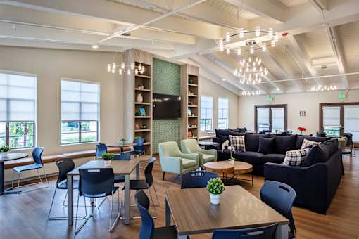 A modern living room with a dining table and chairs.