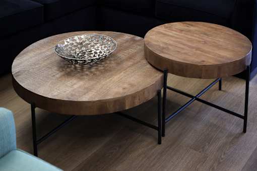 A wooden coffee table with a glass bowl on top.