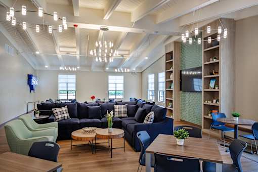 A modern living room with a large sectional sofa, a coffee table, and a TV.