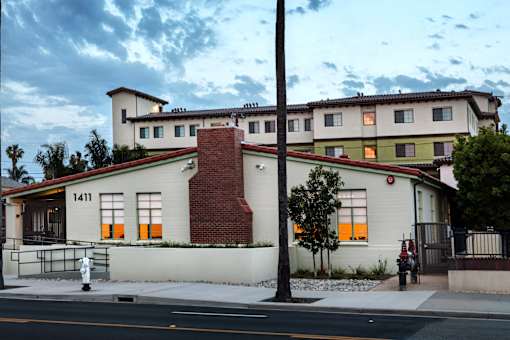 A white building with a red roof and a number 1411 on it.