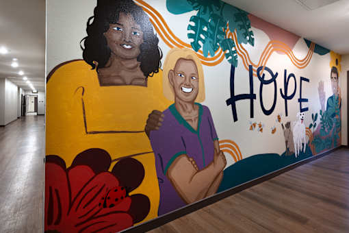A mural of two women with the word "hope" written above them.