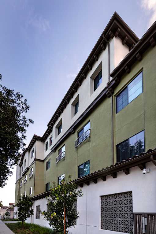 A white building with green trim and windows.