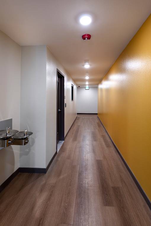 A long hallway with a red light on the ceiling.