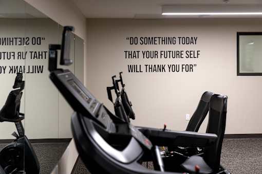 A gym with a motivational quote on the wall.