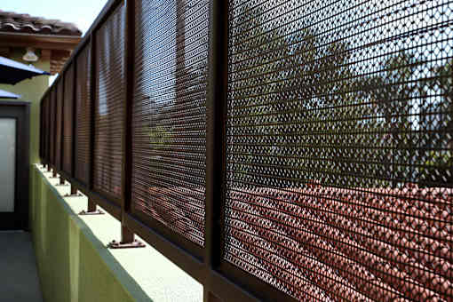 A close up of a brown mesh fence.