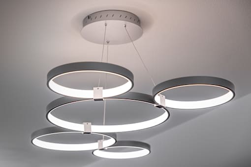 A modern chandelier with circular lights hanging from the ceiling.
