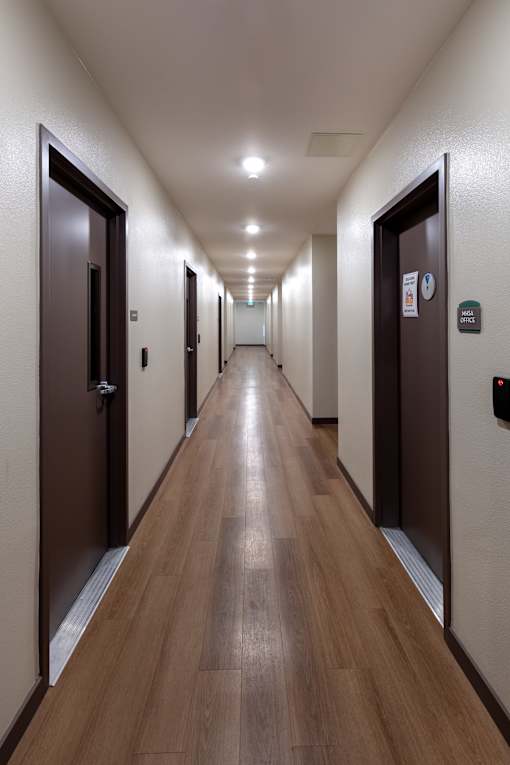 A long hallway with doors on both sides.