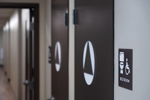 A sign on a door indicates that it is a restroom.