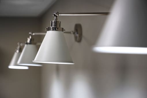 Three lights are hanging from a silver fixture.