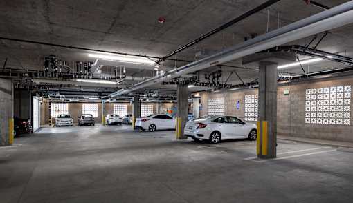 A parking garage with cars parked in it.
