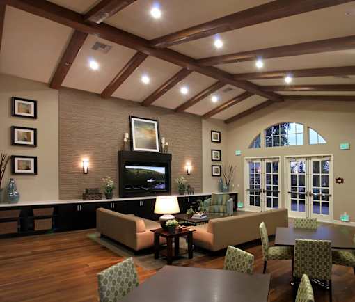 A living room with a flat screen TV and a fireplace.