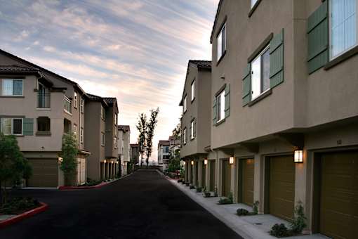 A long street with apartment buildings on both sides.