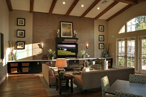 A living room with a couch, chairs, and a television.