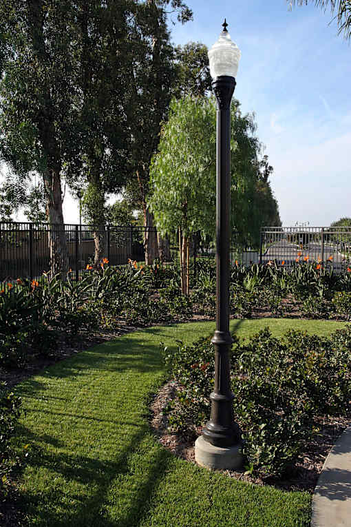 A black lamp post stands in a grassy area.